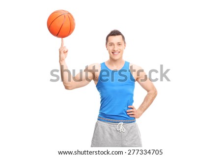 Young cheerful sportsman spinning a basketball on his finger and looking at the camera isolated on white background