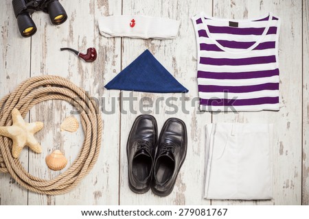 Bunch of sailor clothes and equipment on a white hardwood boat deck