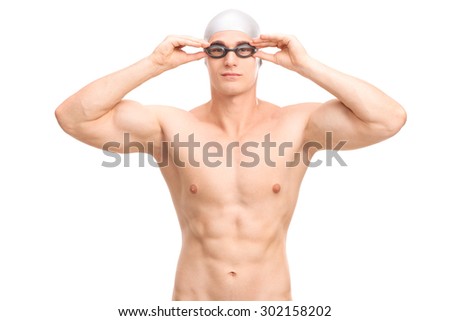 Studio shot of a young male swimmer with a gray swim cap and black swimming goggles isolated on white background
