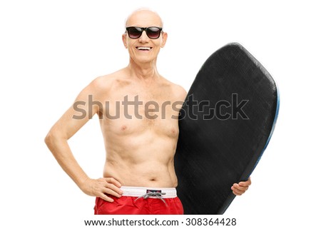 Senior man in blue swim trunks holding a surfboard and looking at the camera isolated on white background