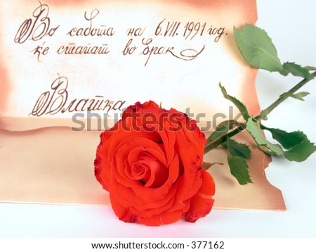Red rose and a wedding invitation