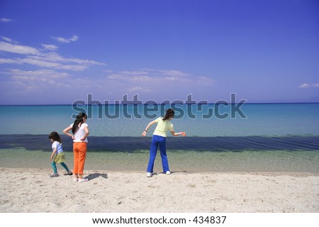 Children throwing stones on the beach