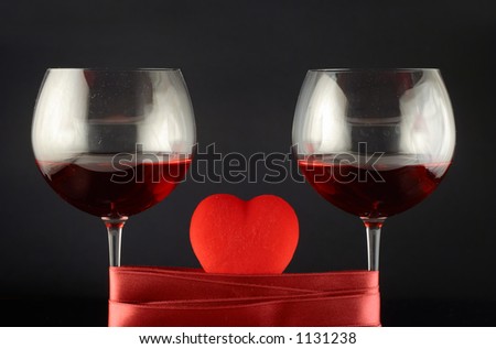 Two wine glasses wrapped with tape and heart