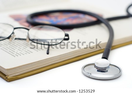 Stethoscope and glasses on a medical book