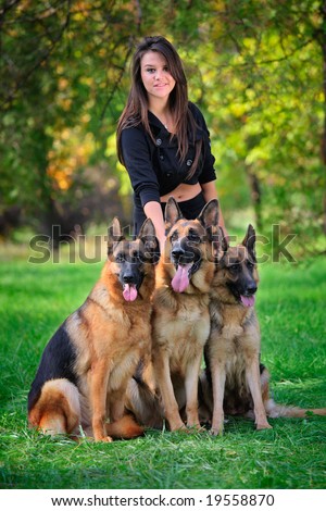 Teenage girl with three German Shepherd dogs