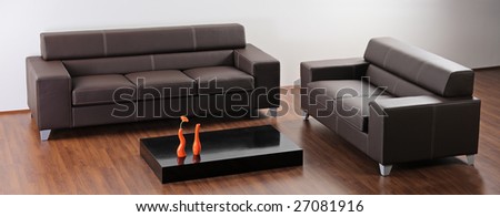 A modern minimalist living room with black furniture