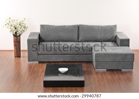 A modern minimalist living-room with grey furniture