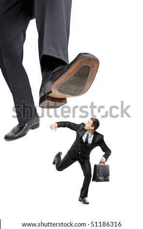 An affraid businessman running away from a big foot isolated on white background