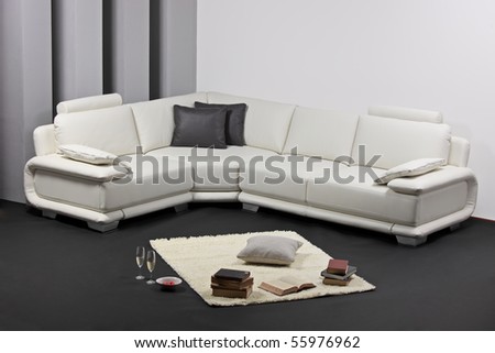 A modern minimalist living-room with white furniture