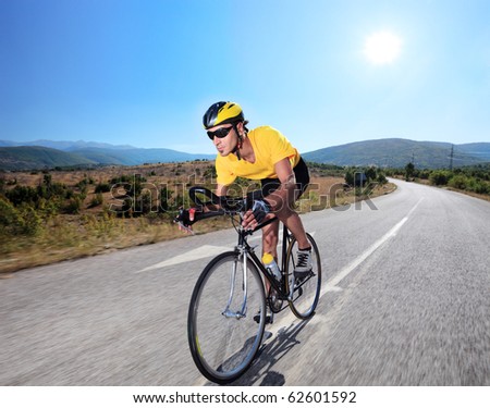 Cyclist riding a bike on an open road in Macedonia