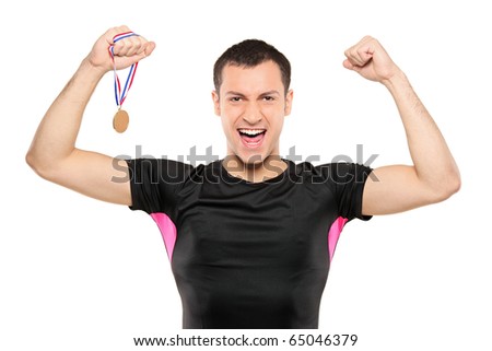 Young happy sportsman holding a gold medal isolated on white background