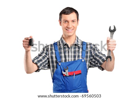 Mechanic in uniform holding a car key and wrench isolated on white background