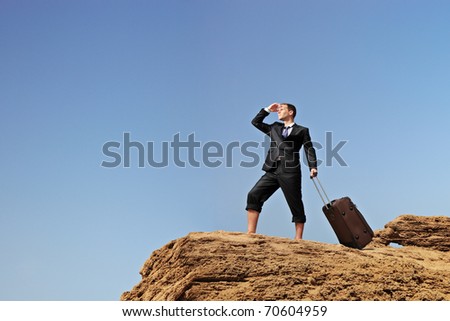 Full length portrait of a lost businessman with a suitcase searching for a way