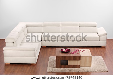 A studio shot of a modern minimalist living room with white furniture