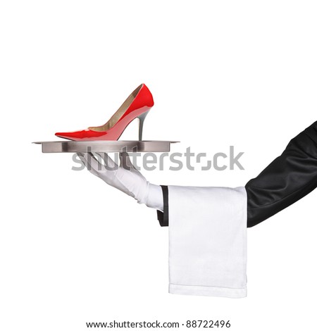 A waiter holding a silver tray with a red high heel on it isolated on white background