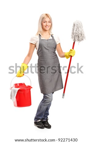 Full length portrait of a female cleaner holding a bucket with cleaning supplies and and floor cleaner isolated on white background