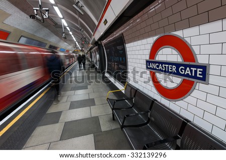 LONDON - MARCH 07, 2015: London Underground sign with moving train and people at Lancaster Gate station. The station is the easy access to tourist attractions; Kensington Palace and Hyde Park.