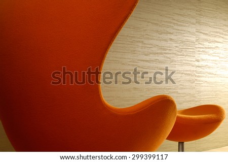 High Back Chair with Footstool in office hallway against wallpapered wall