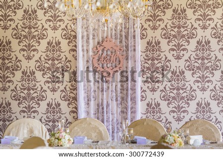 Letters in wedding interior. Served for banquet tables in a luxurious interior.