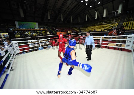 BANGKOK - AUGUST 2: Ali Saher Abdulwahid (L) of Iraq fights Kang Wang of China at Thai boxing event during the 1st Asian martial arts games 2009 August 2, 2009 in Bangkok, Thailand.