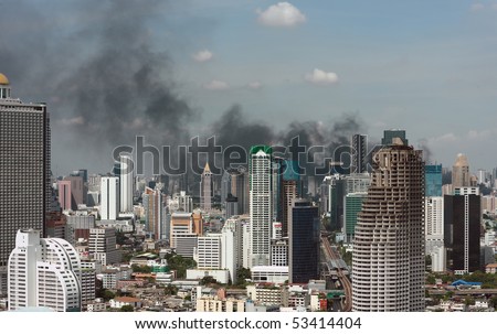 BANGKOK - MAY 19 : Smoke billow as red-shirt protesters set fire on tires May 19, 2010 in Bangkok.The government armored personnel carriers smash red-shirt protesters barricades and enter Lumpini park