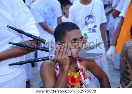 PHUKET, THAILAND - OCTOBER 7 : the ninth lunar month of the Chinese calendar starts  the Vegetarian Festival October 7, 2010 in Phuket, Thailand. Participants in the festival perform acts of body piercing as a means of shifting evil spirits from individua
