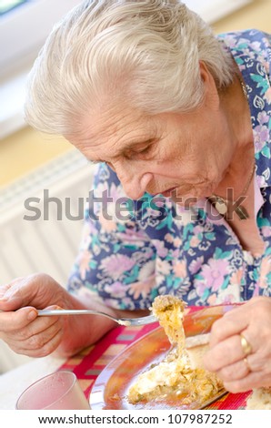 Old woman eating soup