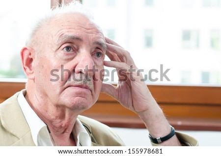 portrait of a senior man thinking about something