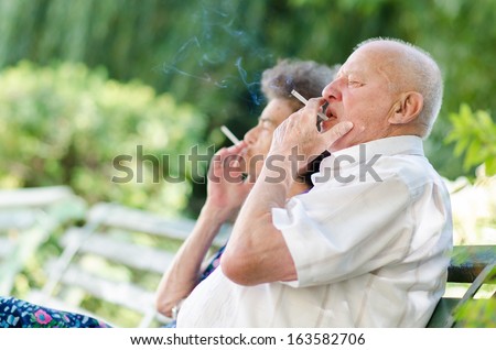 Old man and woman smoking
