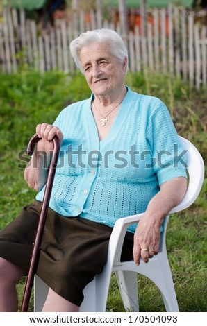 Portrait of a smiling elderly woman outdoor relaxing
