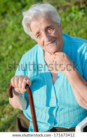 Portrait of a smiling elderly woman outdoor relaxing