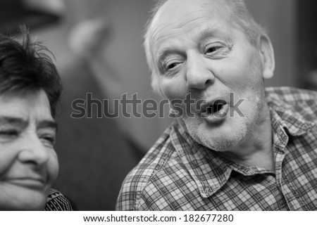 An older man singing at home