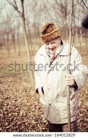 senior people planting trees in the nature