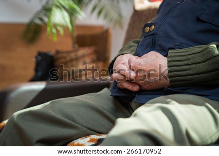 Closeup of an old man's hands joined