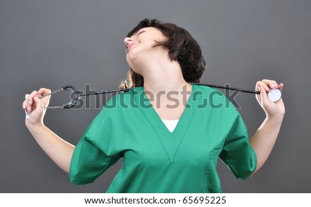 Attractive lady doctor on gray background