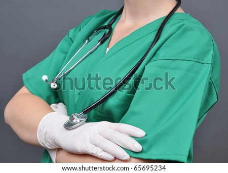 Attractive lady doctor on a over gray  background