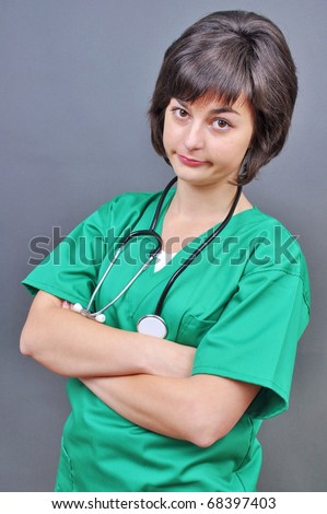 Attractive lady doctor on a over gray background