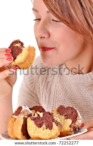 Young beautiful woman eating cookie