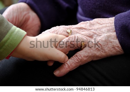 Hands of the old woman and child