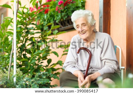 Happy senior woman sitting outside