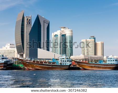 DUBAI, UNITED ARAB EMIRATES (UAE) - JAN 26, 2014: Dhows and the buildings of National Bank of Dubai, Dubai Creek Tower and Al Reem Tower in Rigga Al Buteen Central Business District, Deira, the Creek