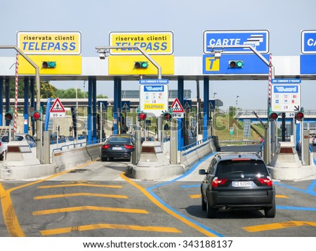 ROME, ITALY - JUL 29, 2013: Cars at Autostrade (motorway, highway) Toll in Italy. Payment with Telepass or card.