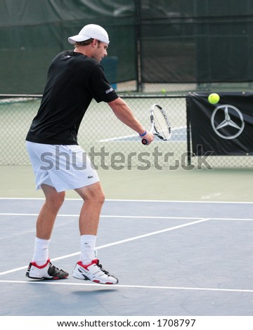 Professional Tennis Player Andy Roddick hitting a volley