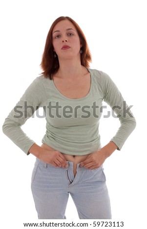 stock photo A young woman tries to close to a tight pants