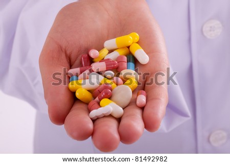 The young doctor with a hand full of pills