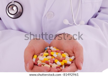 The young doctor with a hand full of pills