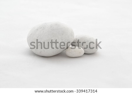 Three white stones on the white background