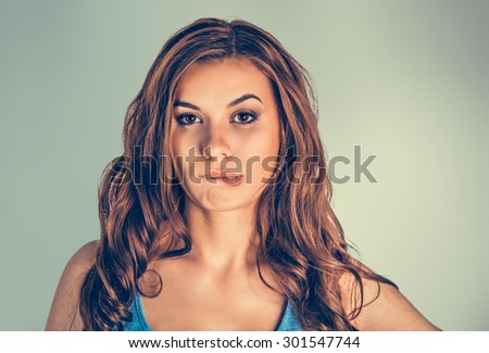 Closeup portrait head shot of sexy beautiful happy young woman biting lips isolated grey green background wall. Human emotions face expressions feeling life perception sensuality desire beauty concept