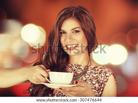 Coffee. Young beautiful girl woman drinking tea cappuccino in trendy cafe shop. Beauty Model with Cup of Hot Beverage. Closeup portrait, warm colors. Human emotions positive facial expressions feeling