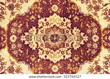 Persian Carpet. Closeup of national popular antique oriental backdrop, beautiful artistic, texture. Abstract repeating design of red blue flower on yellow color style background wallpaper texture.